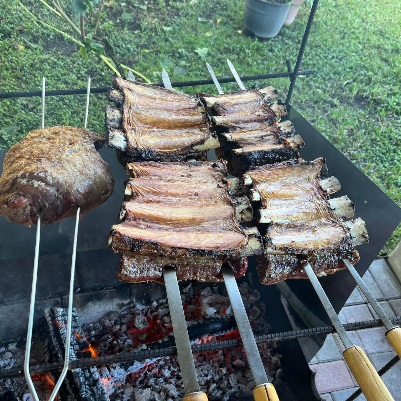 BBQ ribs on skewers over charcoal
